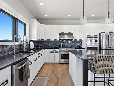 White cabinetry lines the kitchen