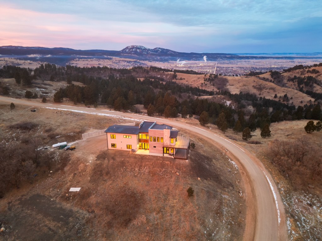 Aerial dusk with pink sky, curved property road