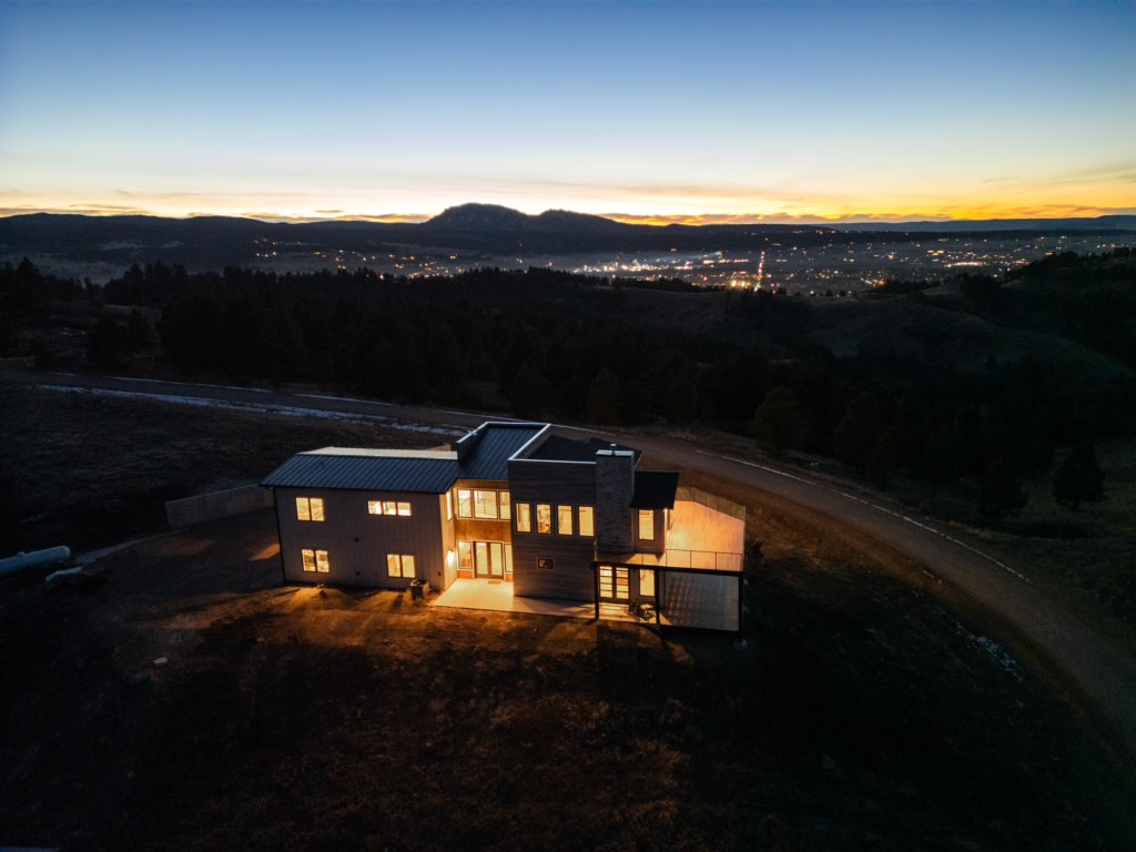 Night aerial, house glowing above the Spearfish valley