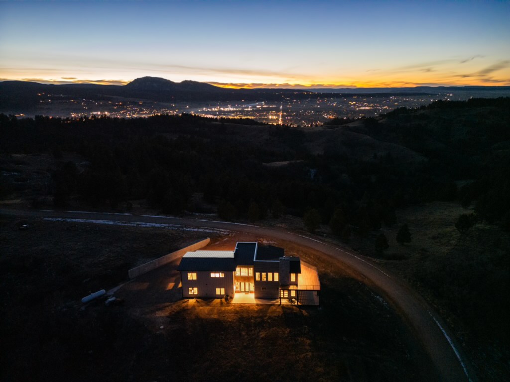 Night aerial with valley lights beyond