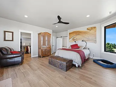 Primary bedroom with live-edge wood slab wall sculpture