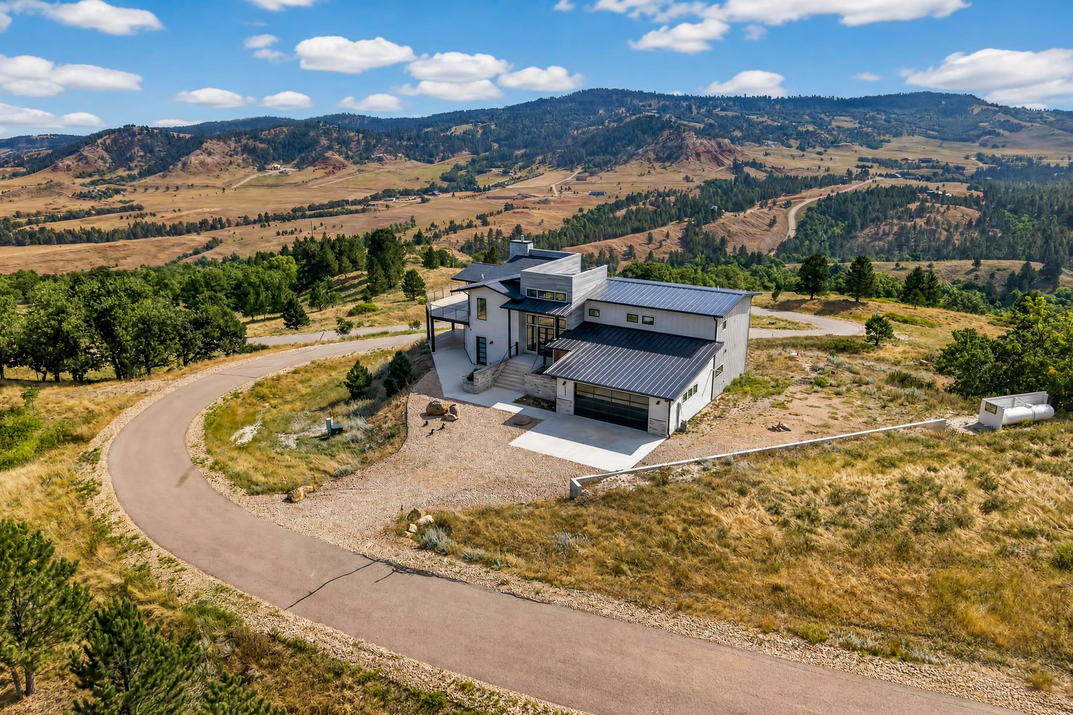 An aerial angle captures the paved driveway loop