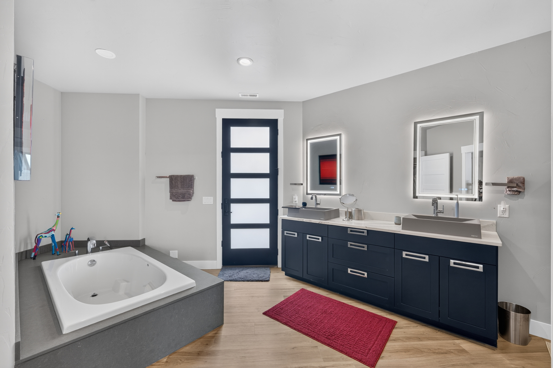 A spacious bathroom with a deep soaking tub