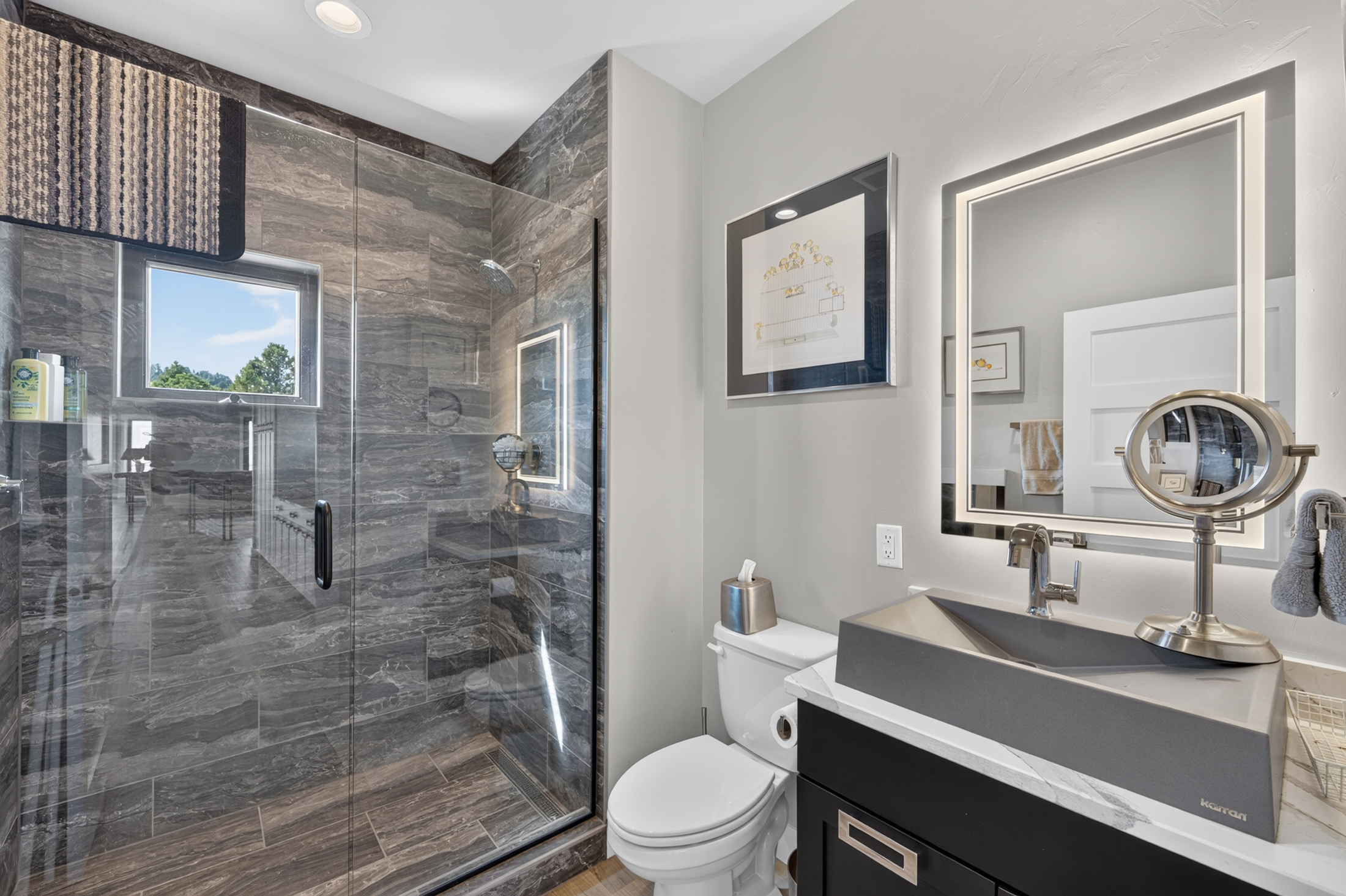 A bathroom features a glass-enclosed tile shower