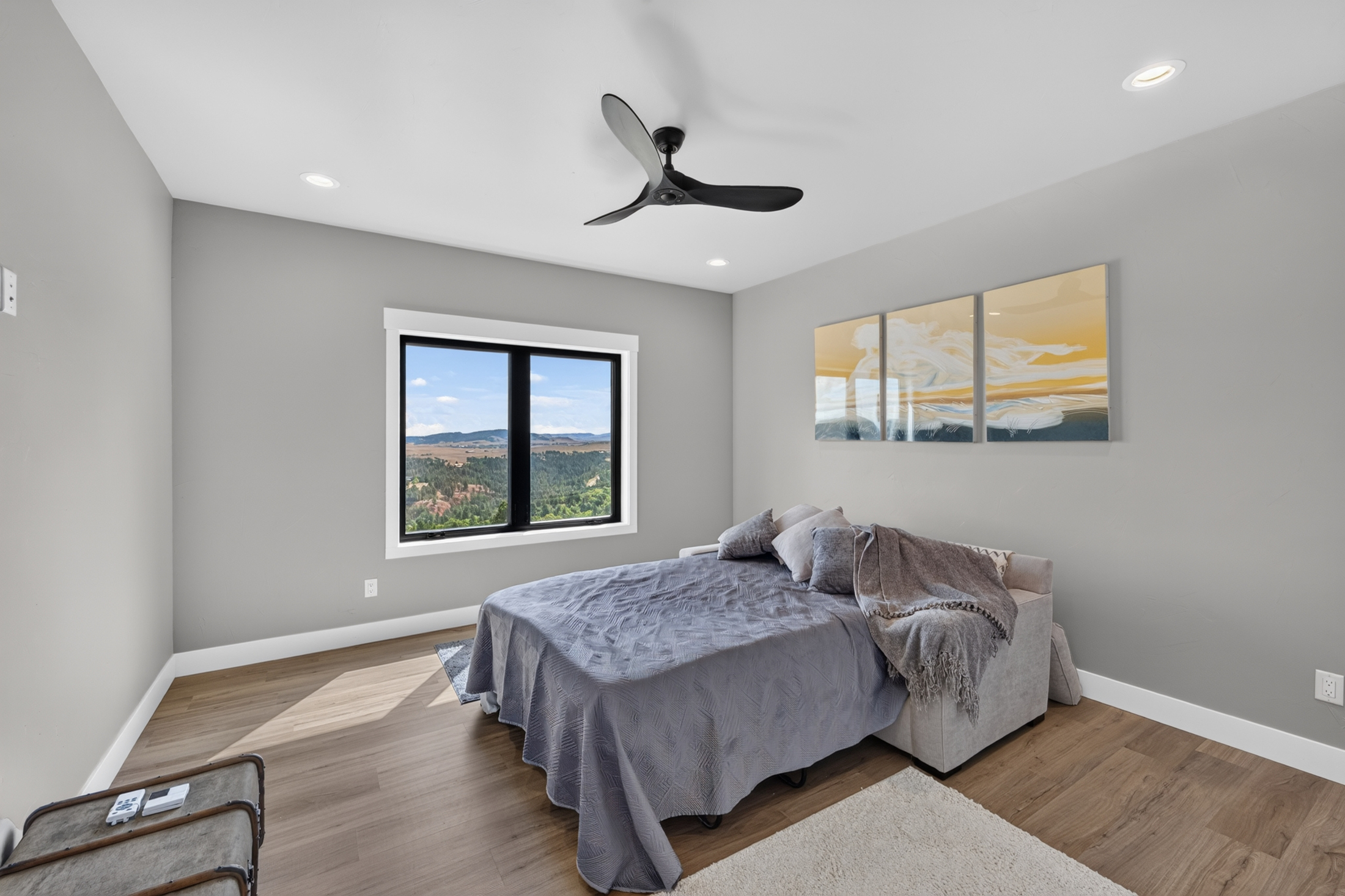 A bedroom at 2111 Vantage Circle has a gray-covered bed