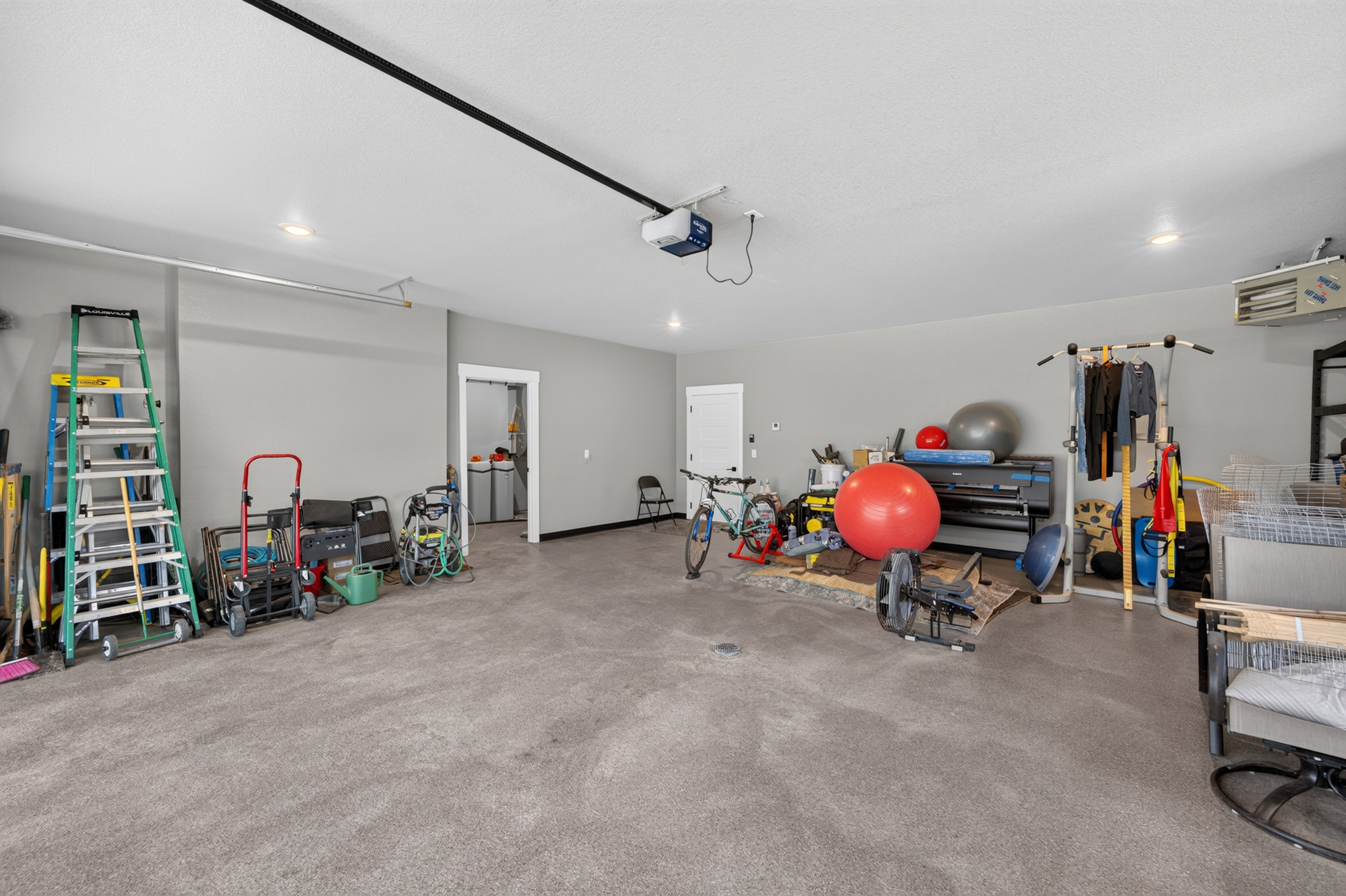 A second garage bay holds a rowing machine