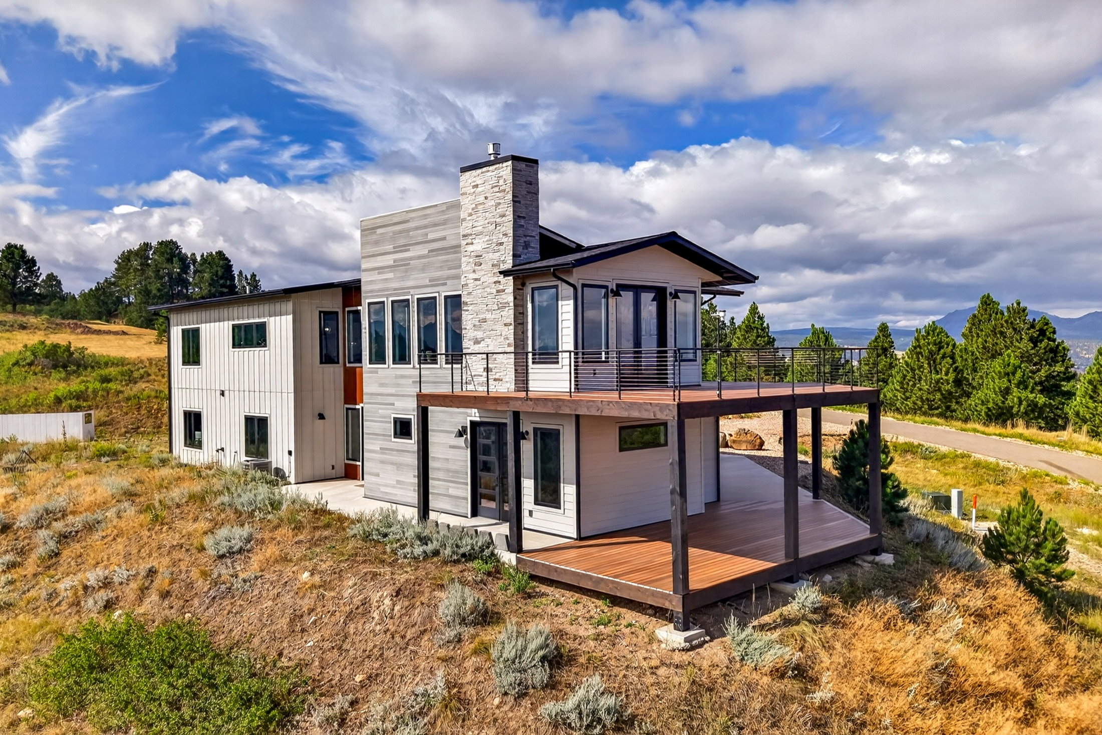 The rear elevation shows a lower walkout deck