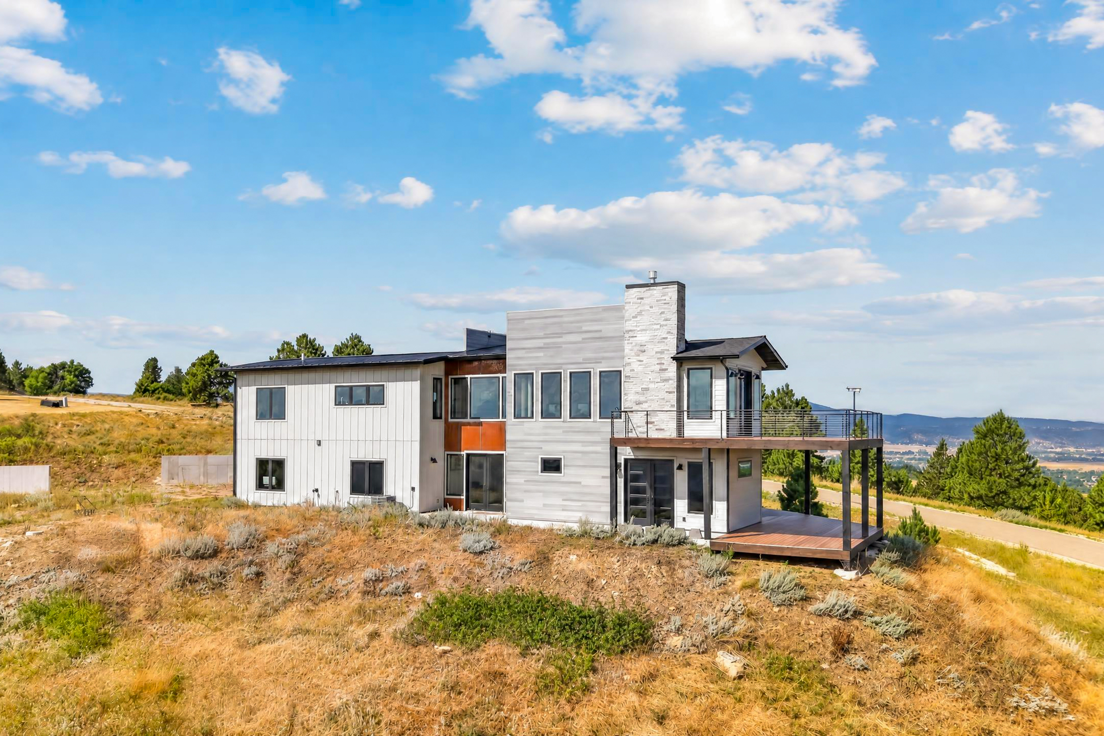 A wide sky frames the rear of the home