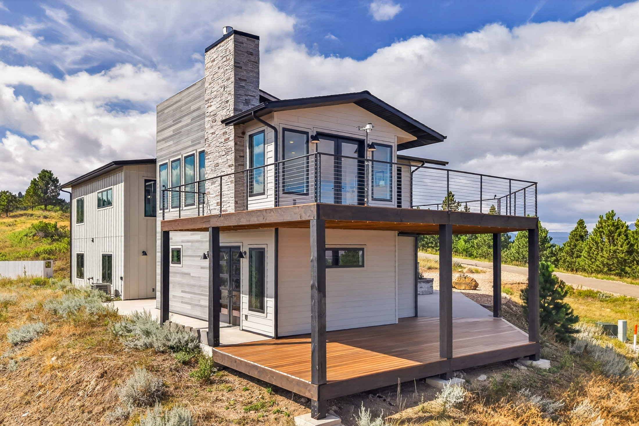 A two-story deck structure wraps the rear of the house
